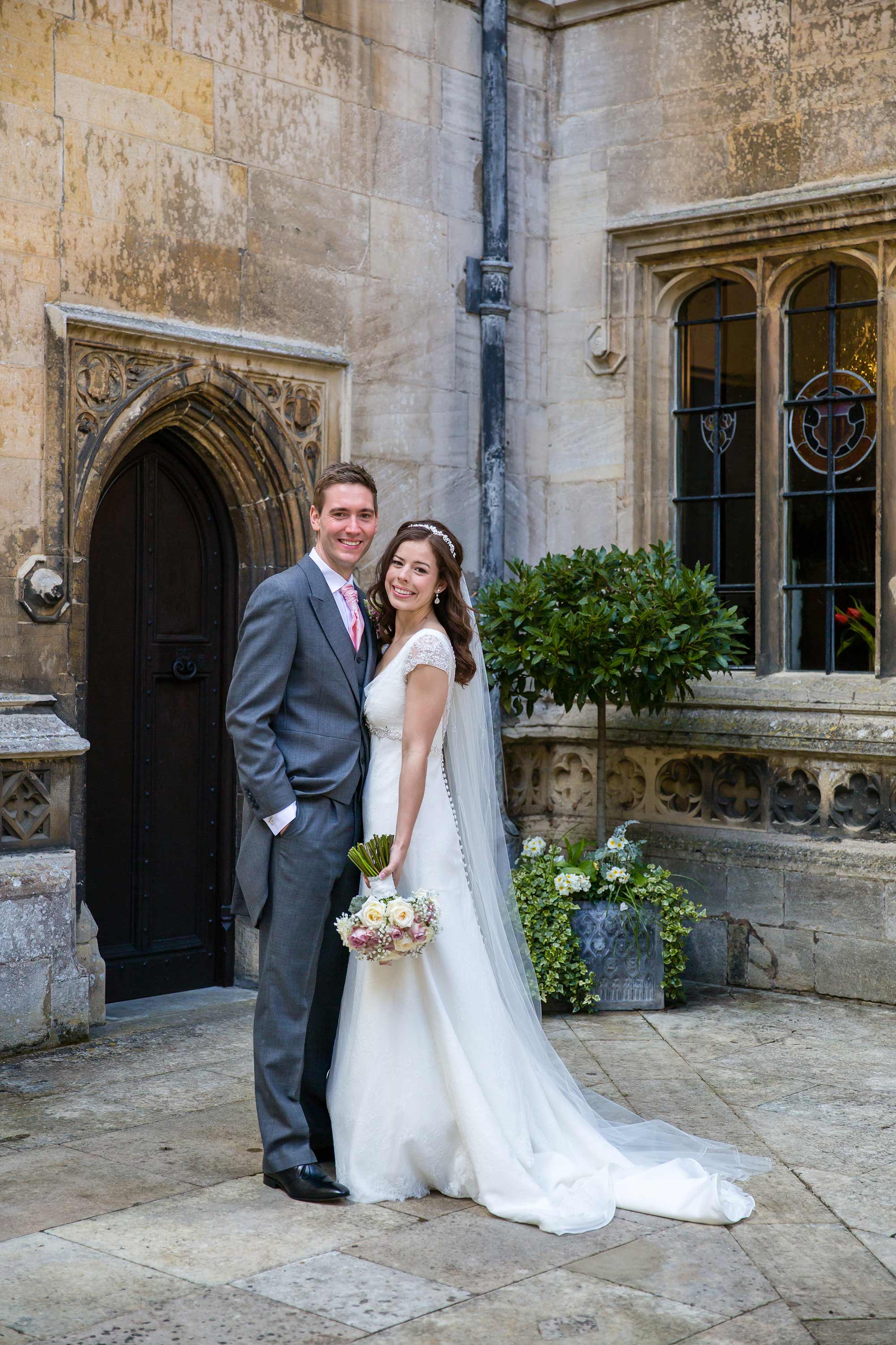 A full length portrait of Amy and Jack in the courtyard of Hengrave Hall.