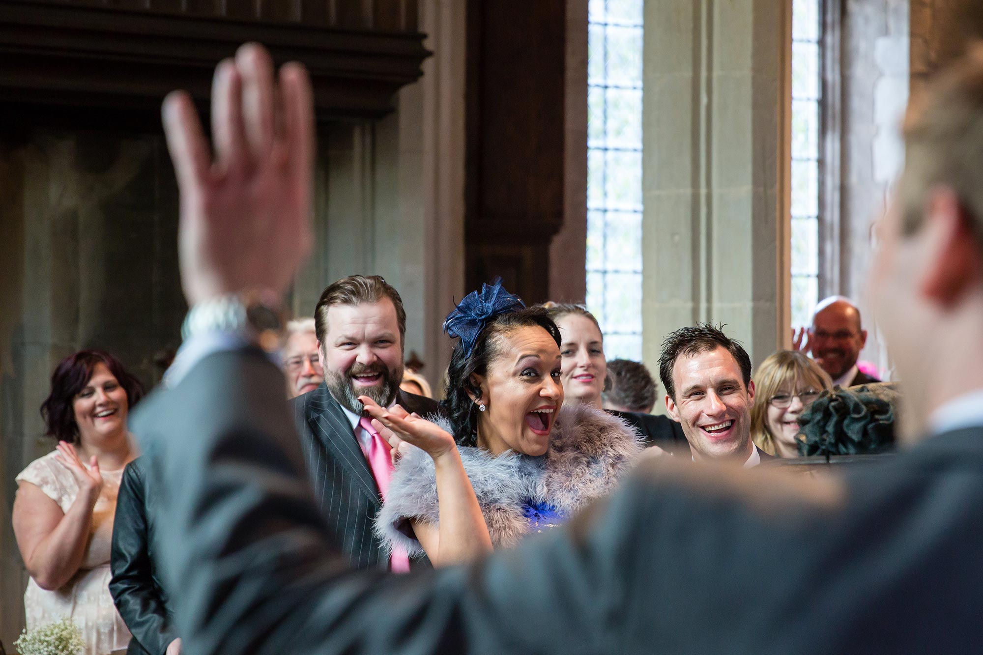 Guests wave during the Hengrave Hall wedding