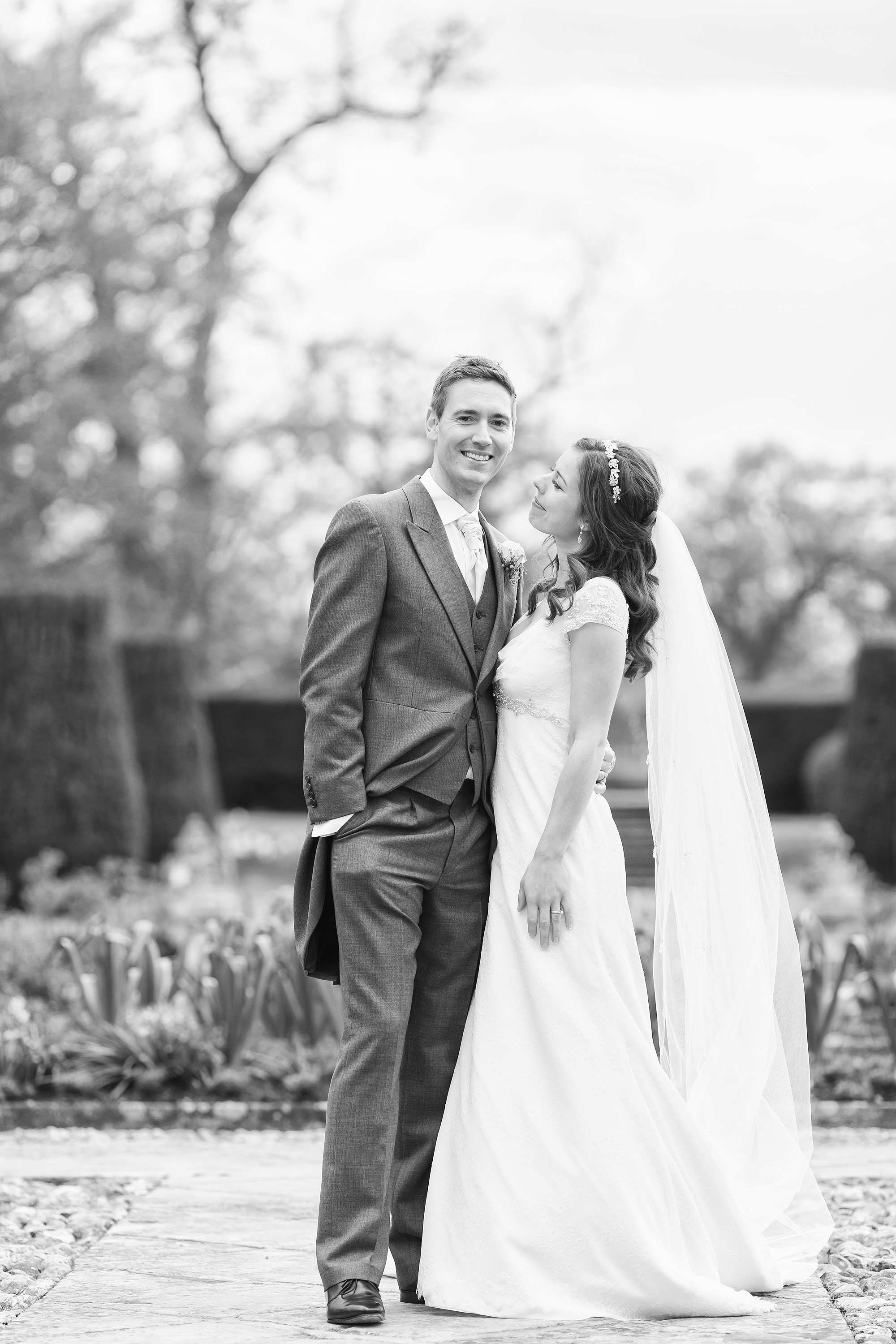 Black and white picture of Amy and Jack looking at each at their Hengrave Hall Wedding
