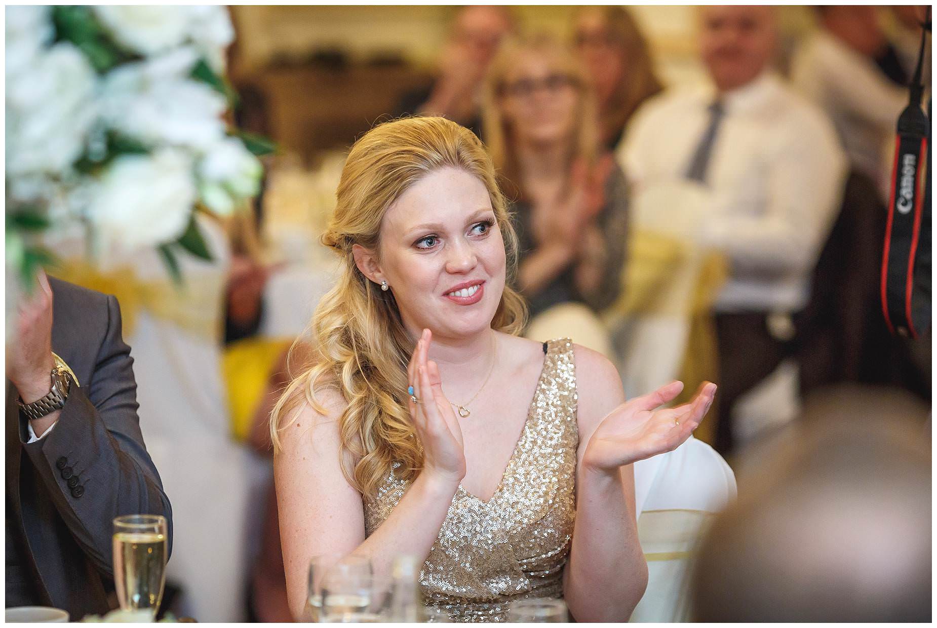 bridesmaid clapping in gold dress