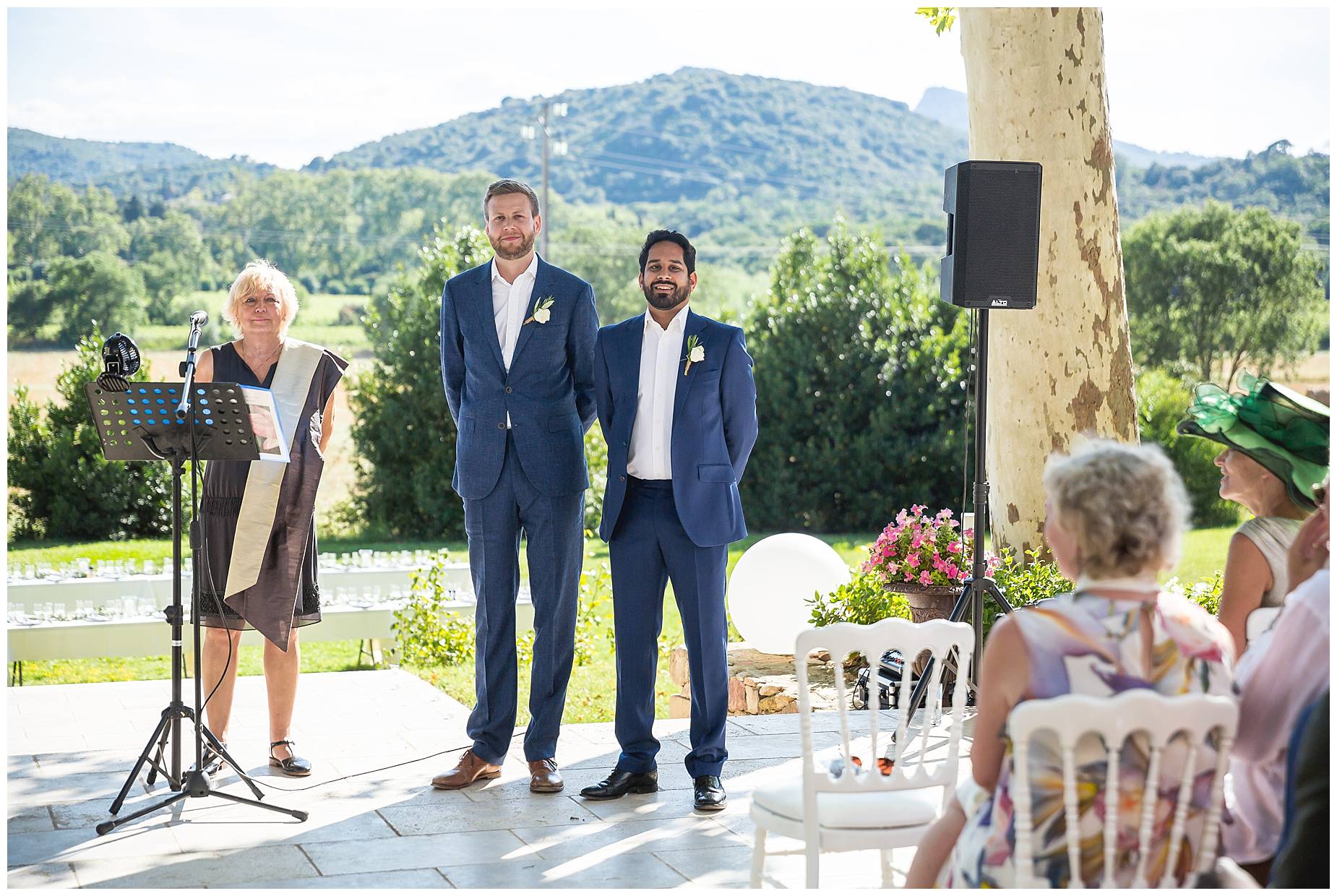 best man and groom wait for bride in outdoor ceremony 