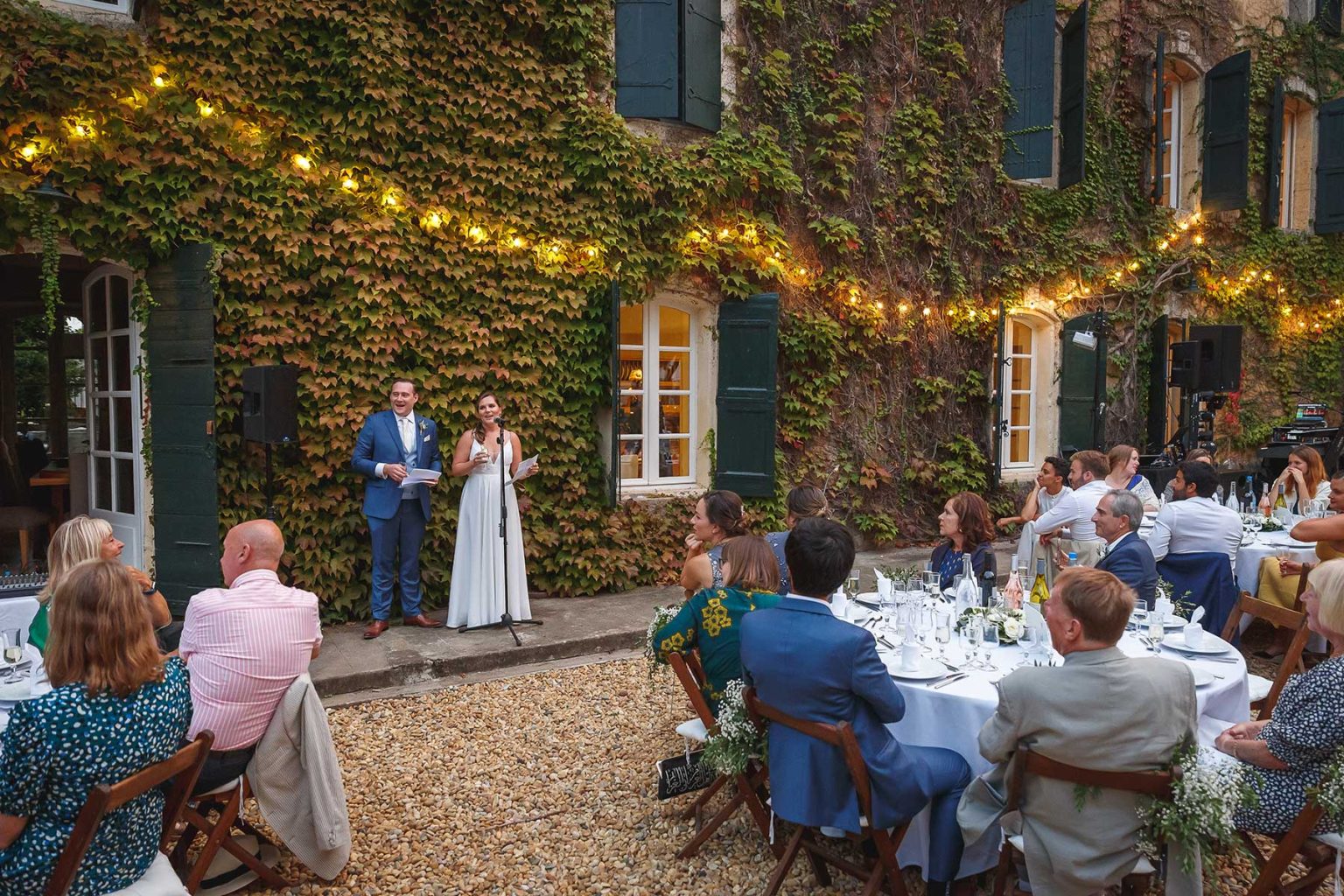 Outdoor wedding ceremony in front of the ivy-covered house at Domaine Saint Hilaire