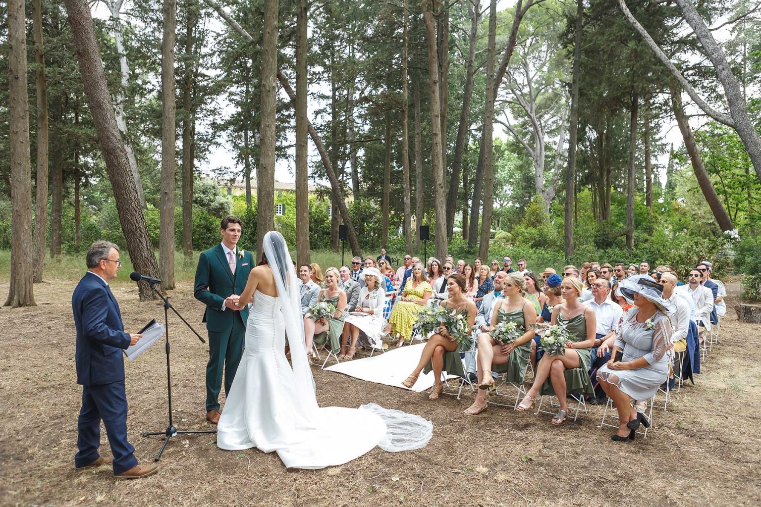 Bride and groom during a woodland wedding ceremony at Domaine Saint Hilaire