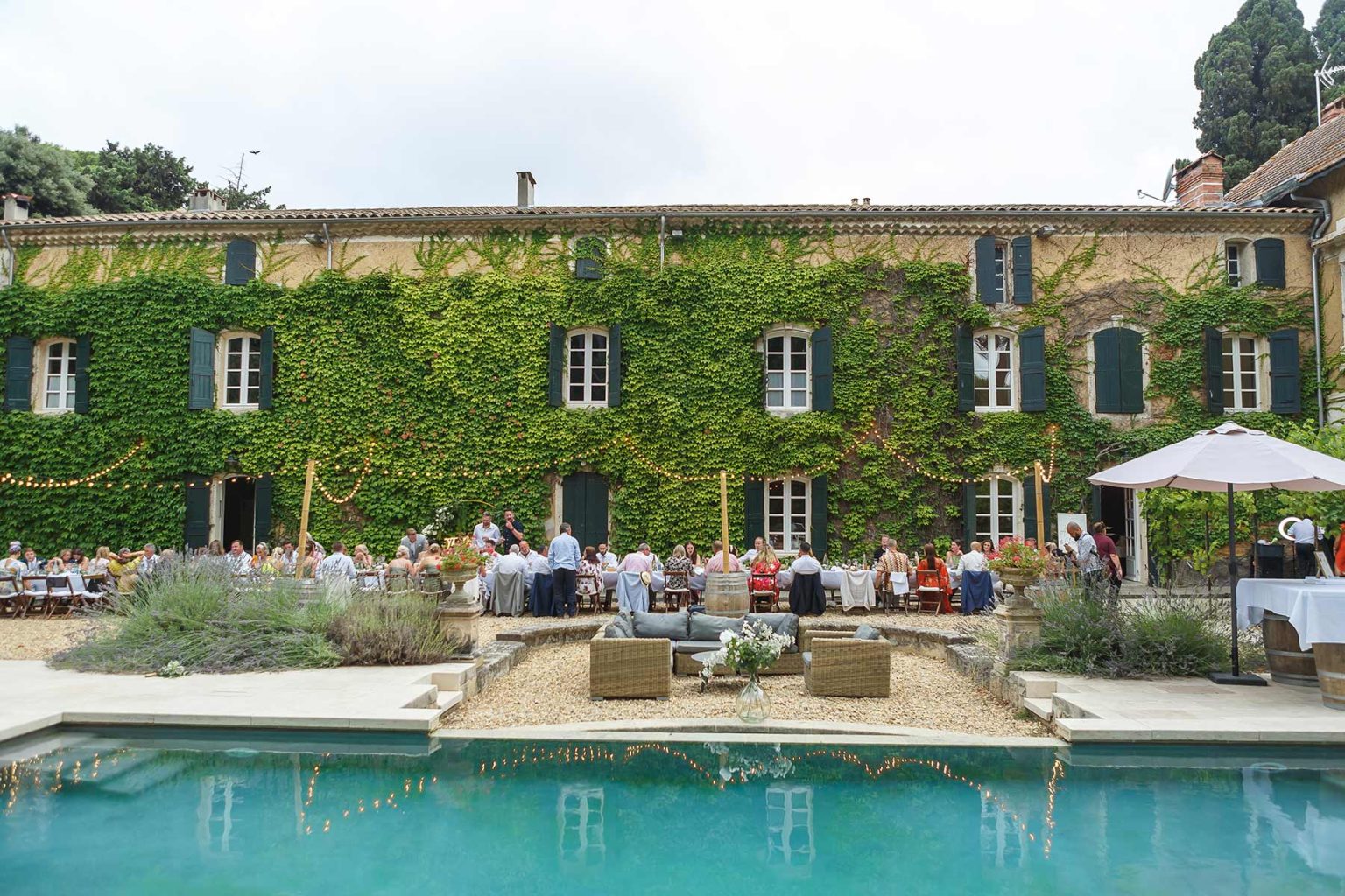 Pool terrace and ivy-covered house at Domaine Saint Hilaire near Montagnac