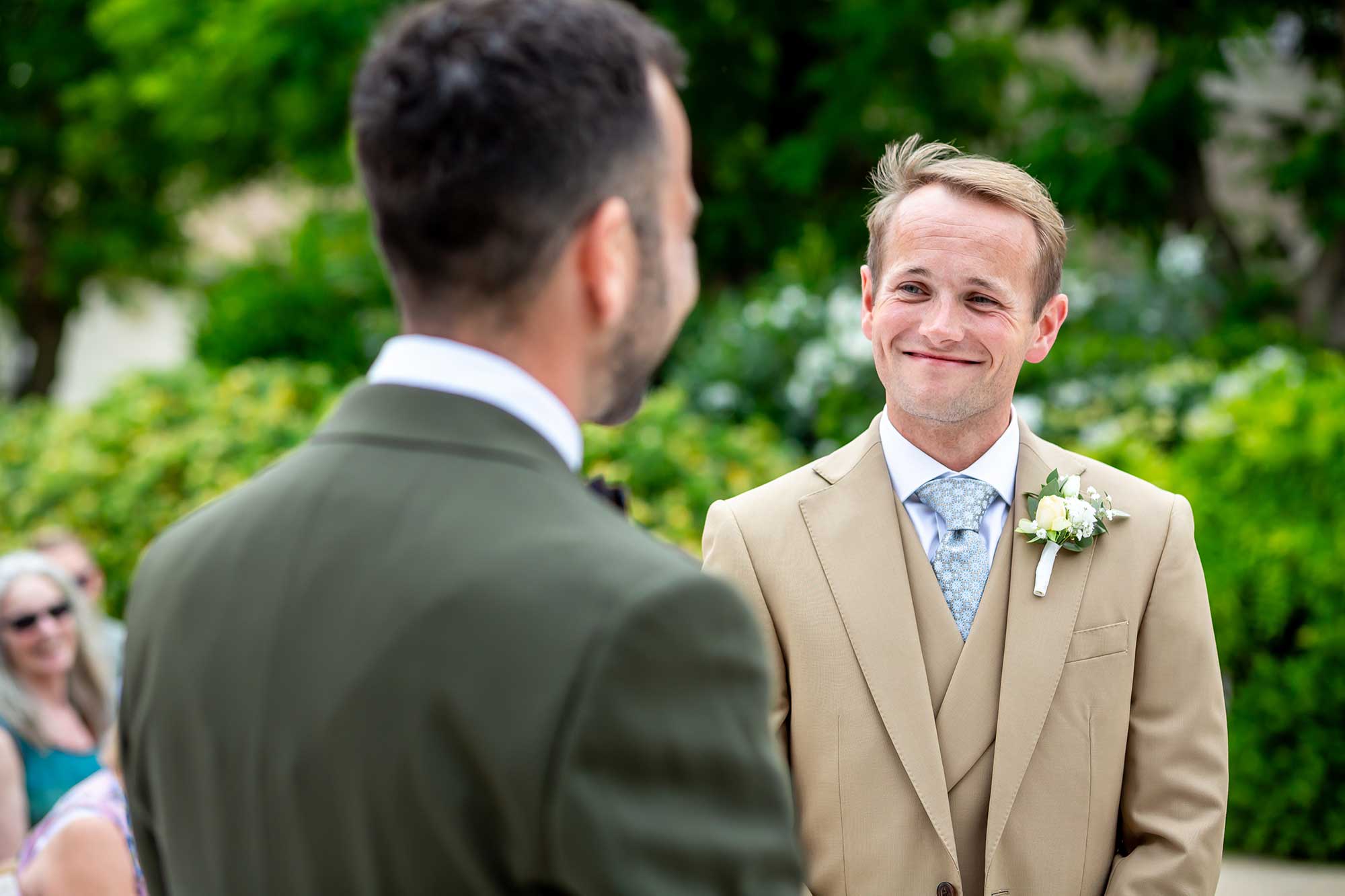 Chateau Carrasses vineyard wedding groom smiles back in ceremony of gay wedding