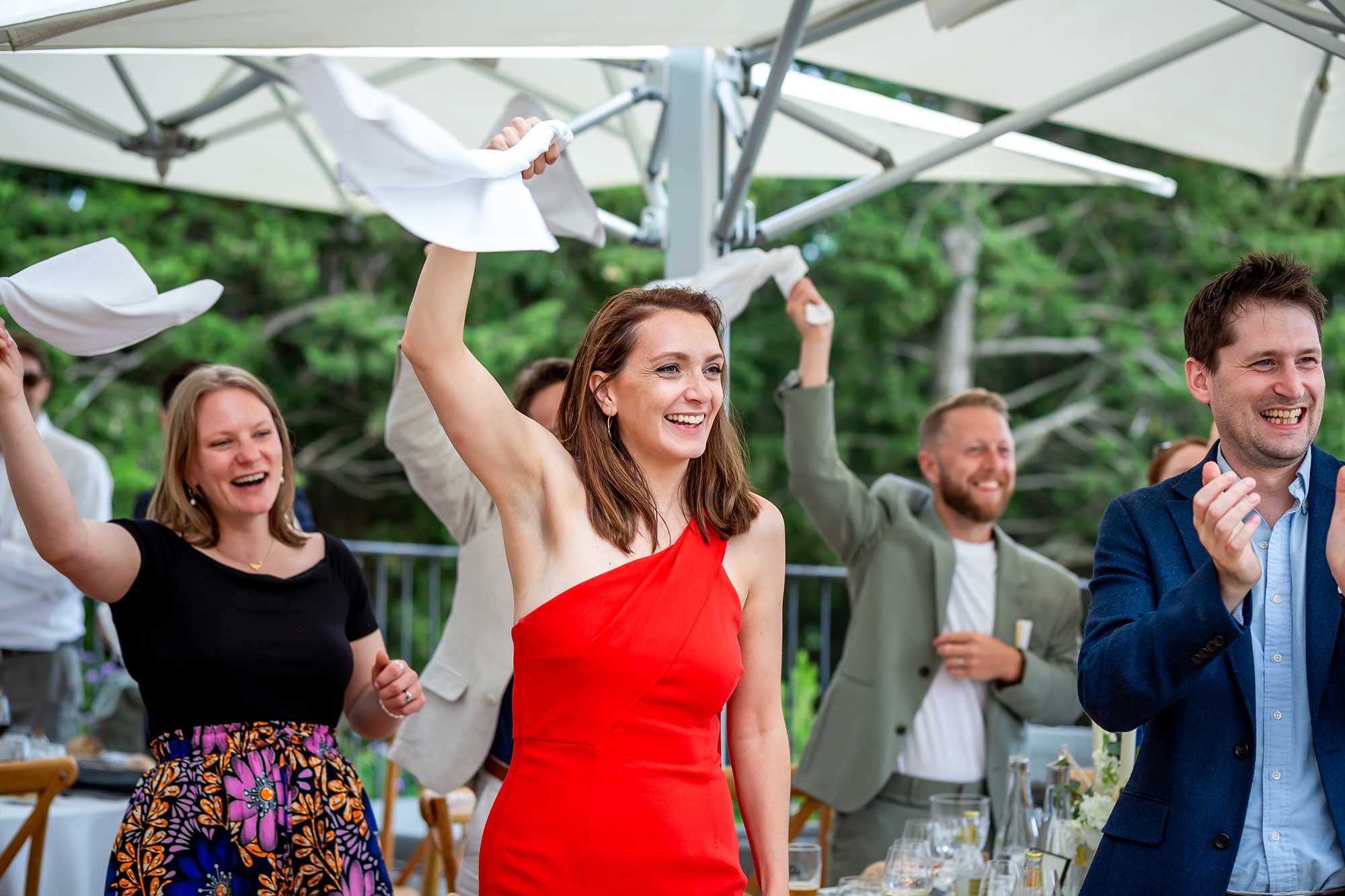 more guests wave their napkins