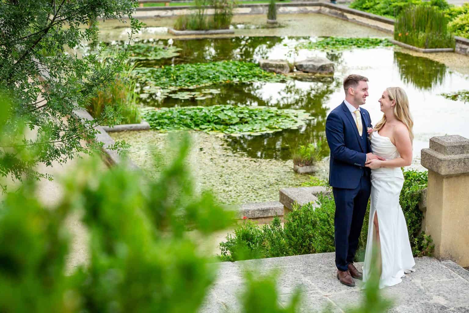 Bride and groom portrait beside the formal gardens at Château de Pondres