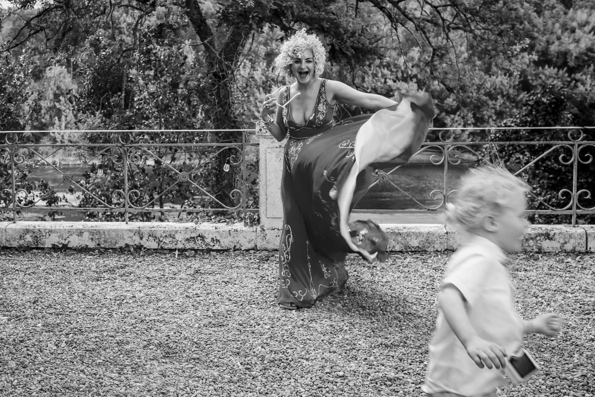 Wind at south of France wedding blows a guest's dress and a child runs from the storm.