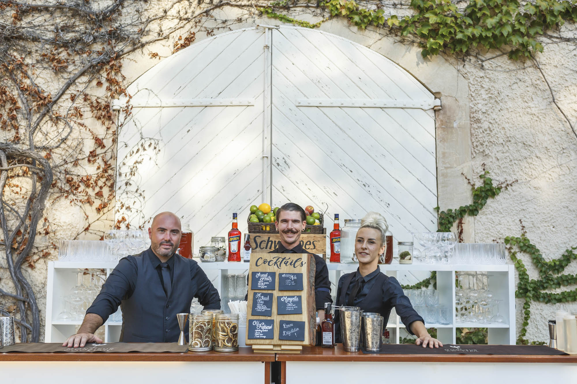 Cocktail waiters behind the bar ready their couple getting married in France