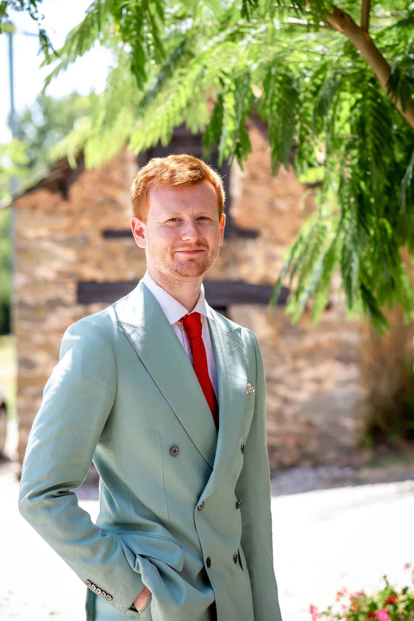 Alexander in his pale green wedding suit outside the family home