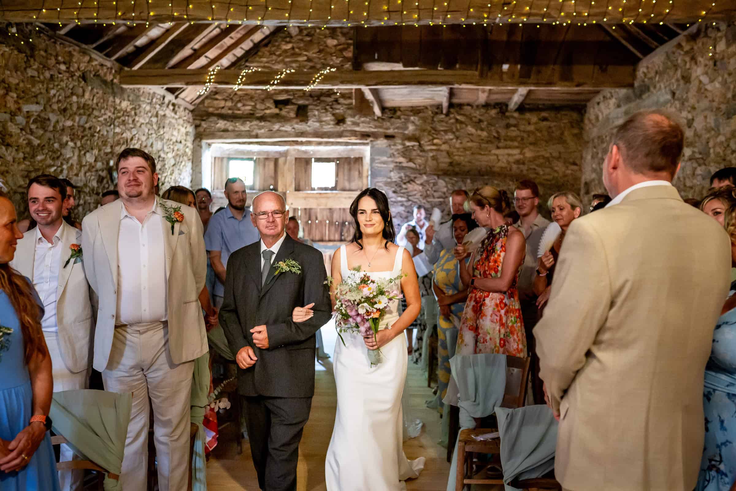 Kayley entering the old stone barn for the ceremony