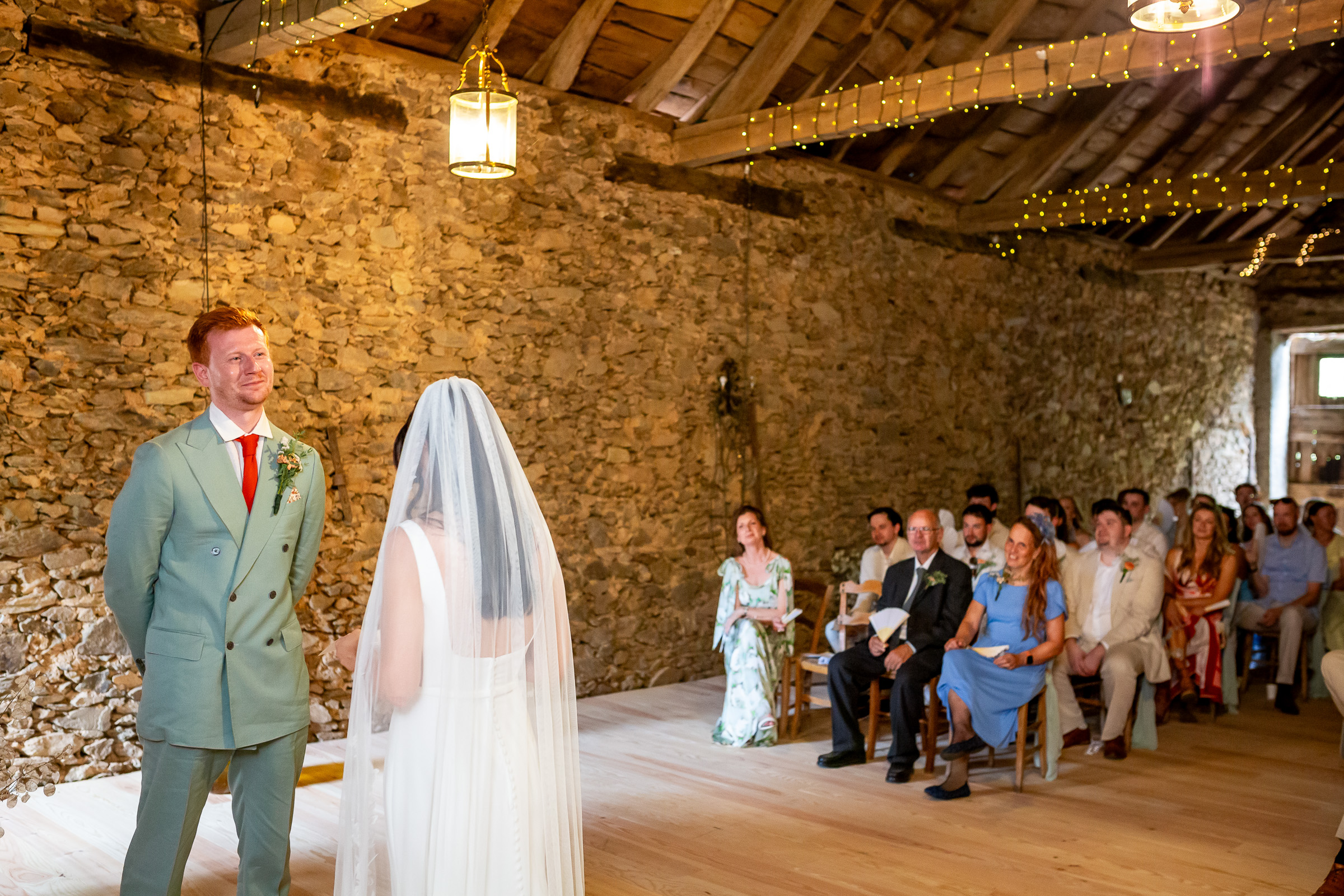 Kayley and Alexander exchanging personal vows in the old stone barn