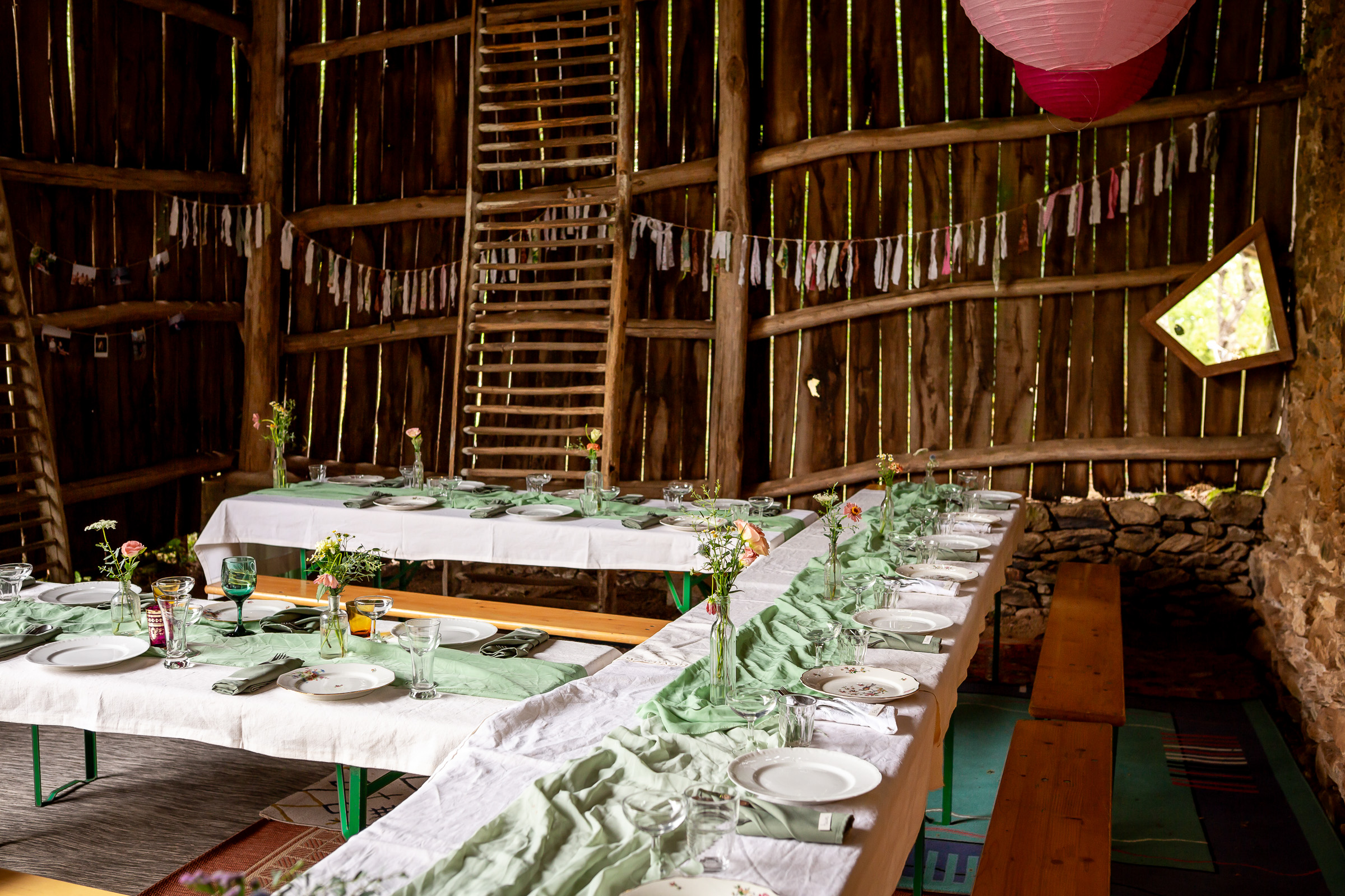 Long reception tables with collected French china at a French countryside wedding