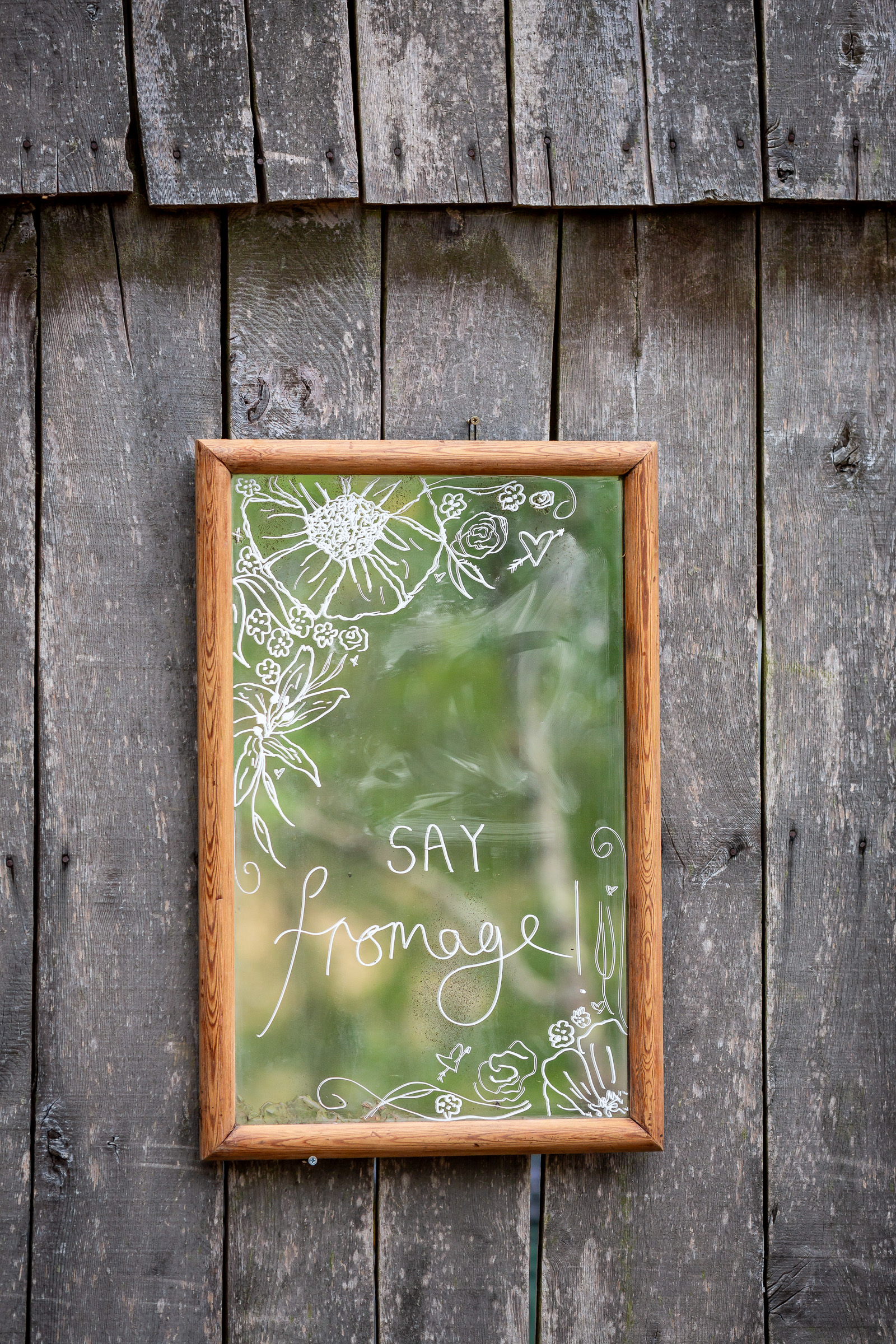 A Say Fromage sign on the side of the old barn