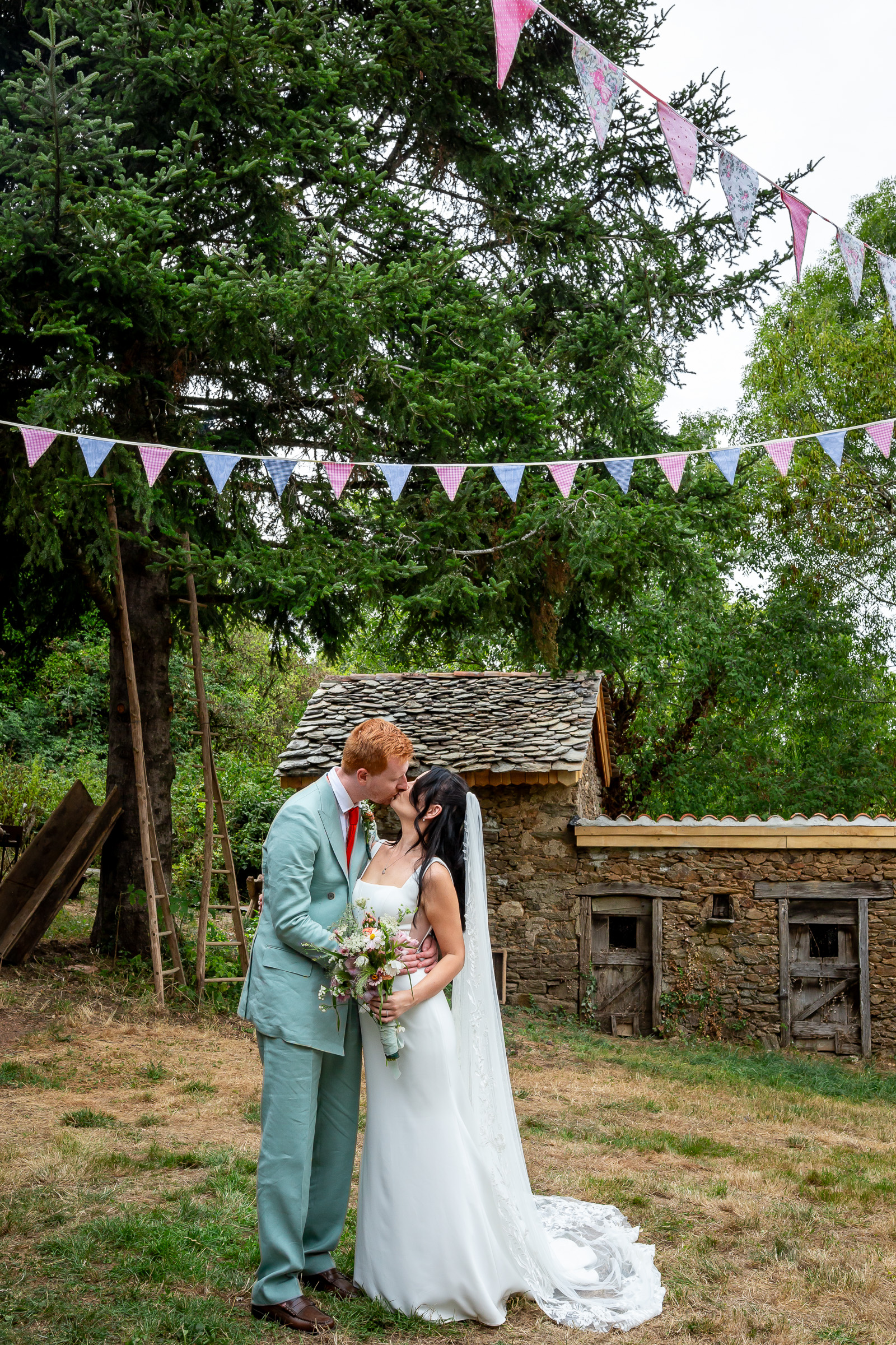 Kayley and Alexander outside an old stone outbuilding at the family home