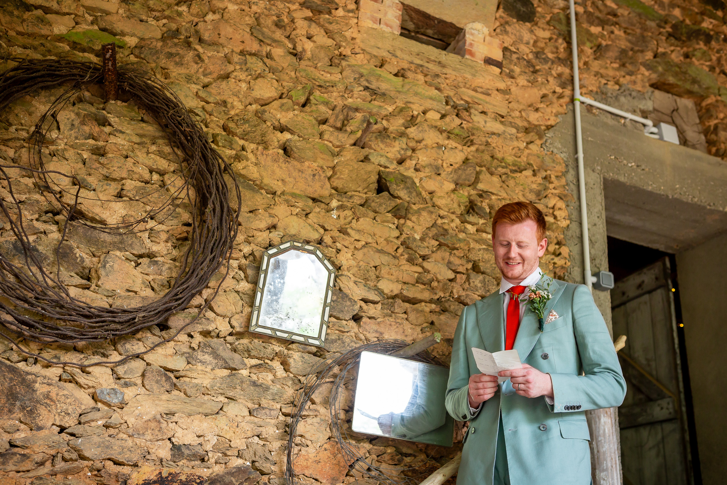 Alexander giving his wedding speech inside the stone barn