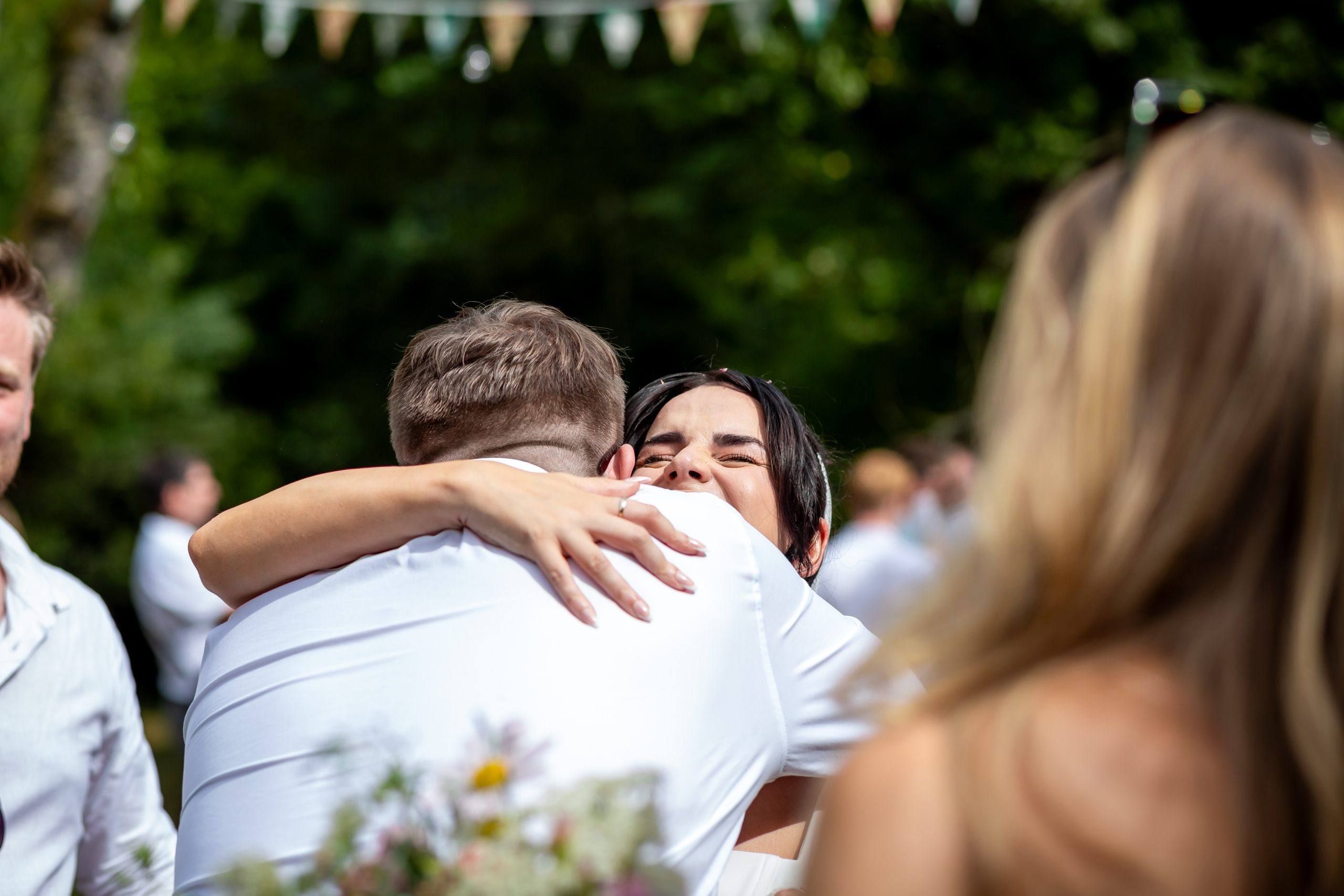 Kayley embracing a guest immediately after the ceremony