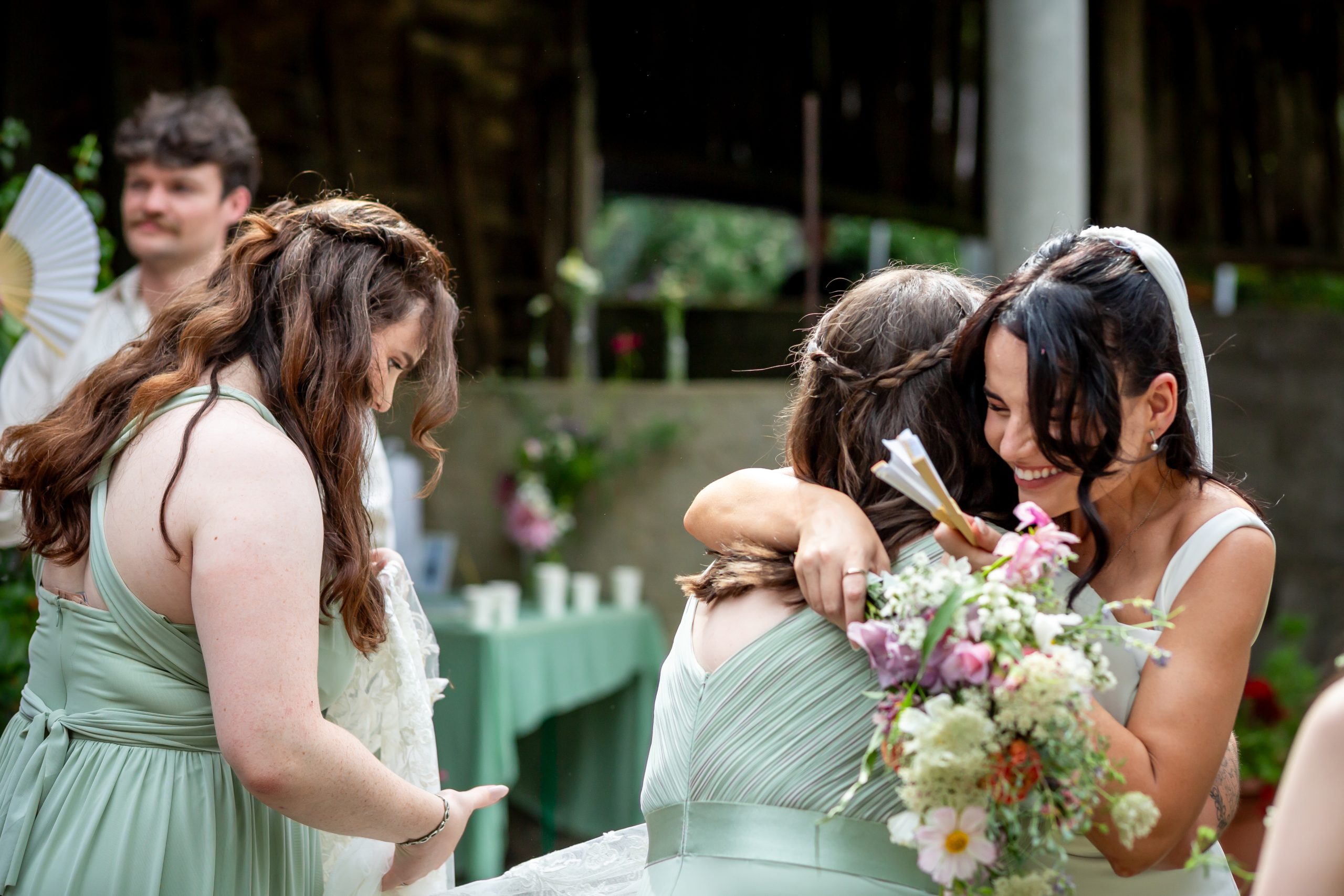 Kayley embracing a friend during the outdoor drinks reception