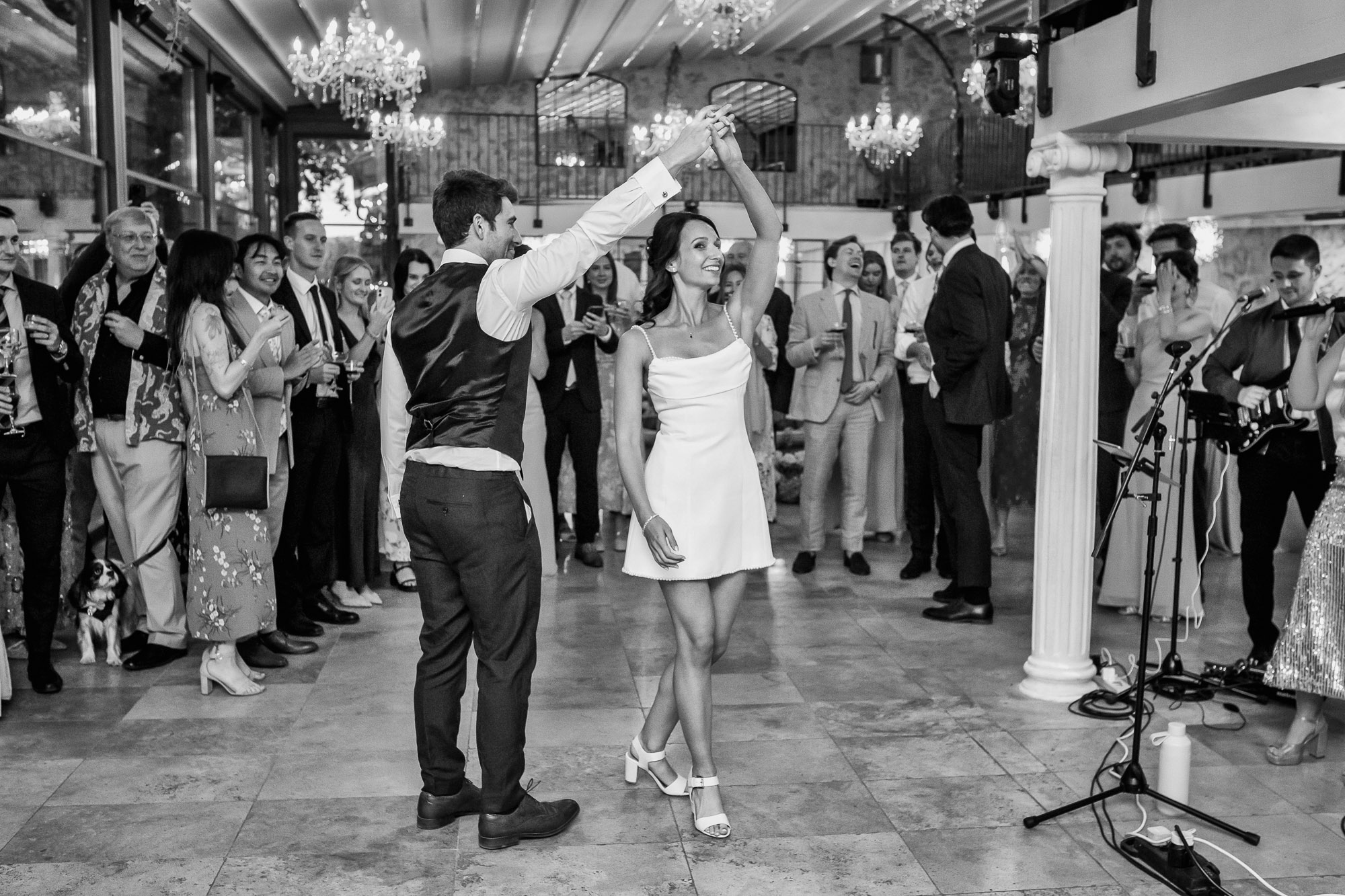 Bride and groom dancing with their guests during an evening wedding reception in Provence