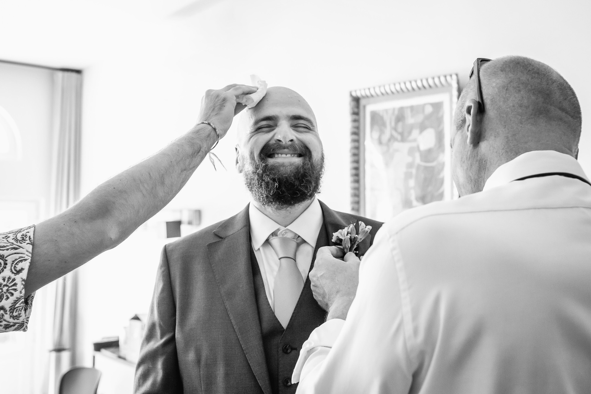 Thomas’s best man wiping sweat from his forehead while he gets ready