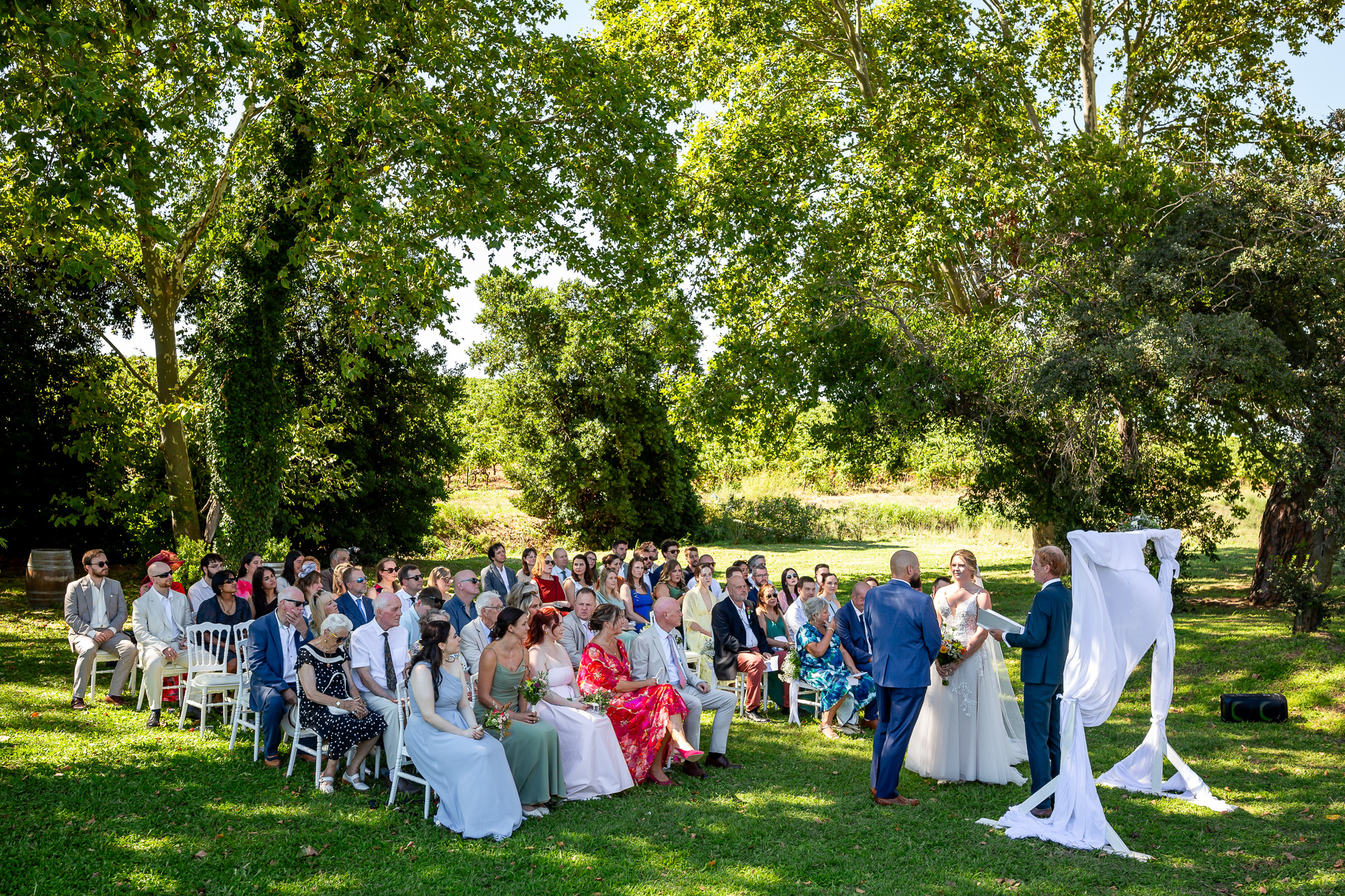 Outdoor wedding ceremony beneath the trees at Château Bellefontaine