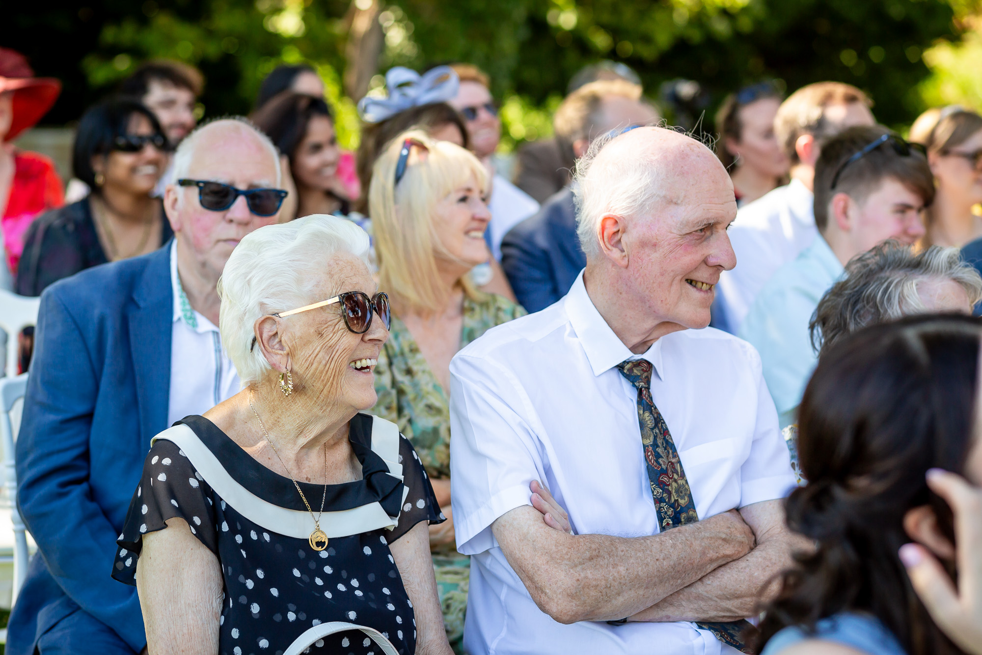 Hannah’s grandparents laughing during the outdoor ceremony
