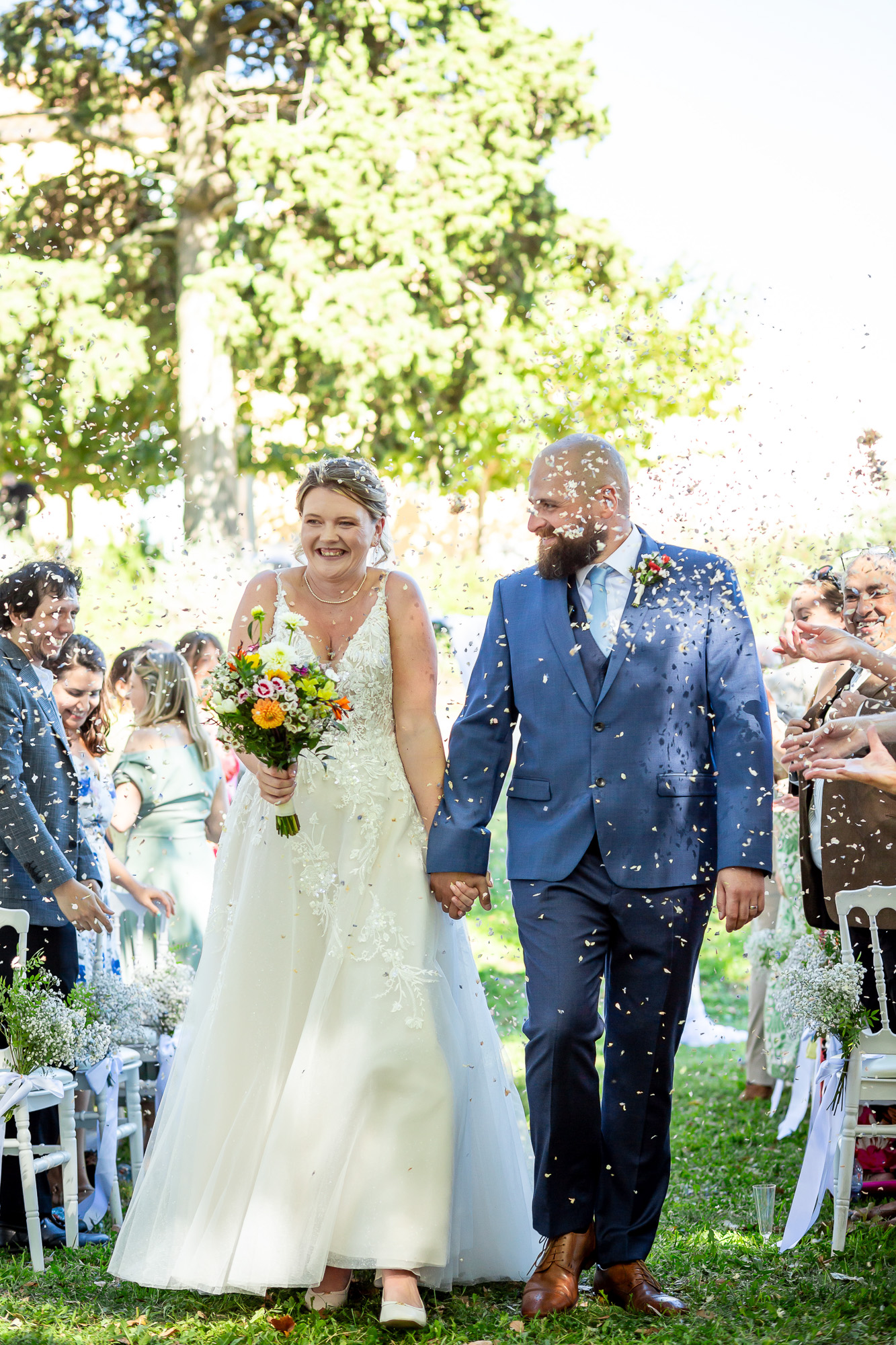 Hannah and Thomas walking back through confetti