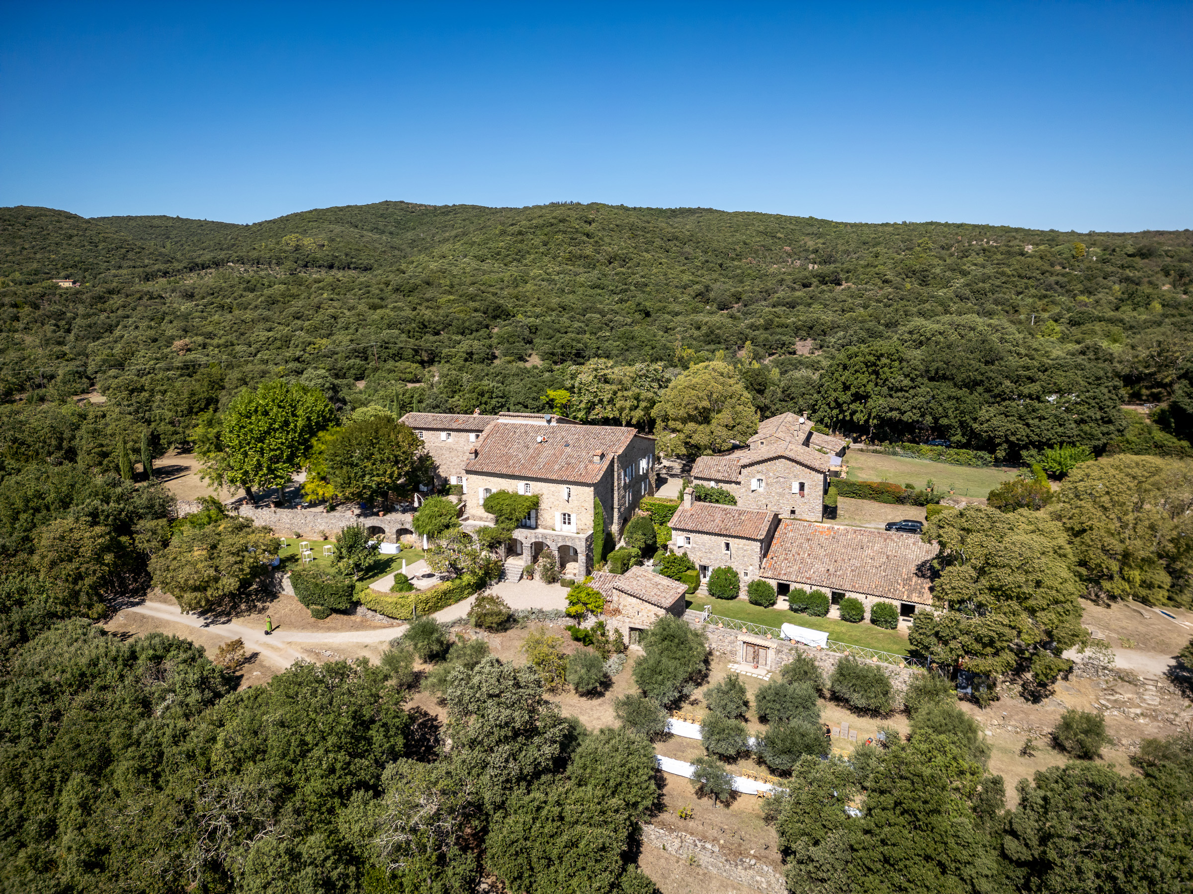 Aerial view of Le Domaine du Rey surrounded by the wooded hills of the Cévennes
