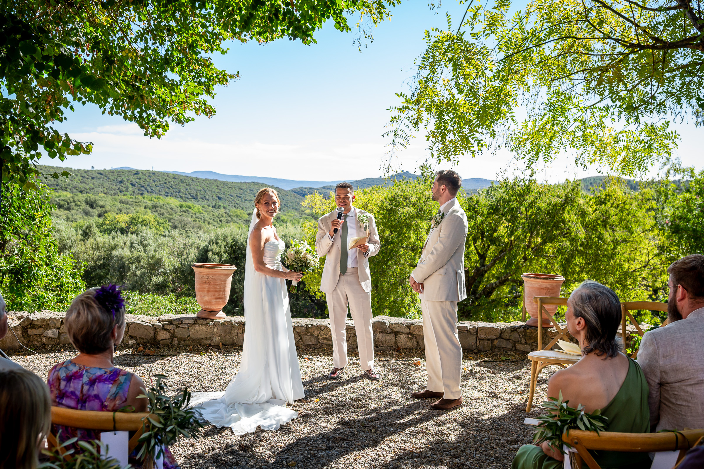 Outdoor wedding ceremony beneath the trees at Le Domaine du Rey