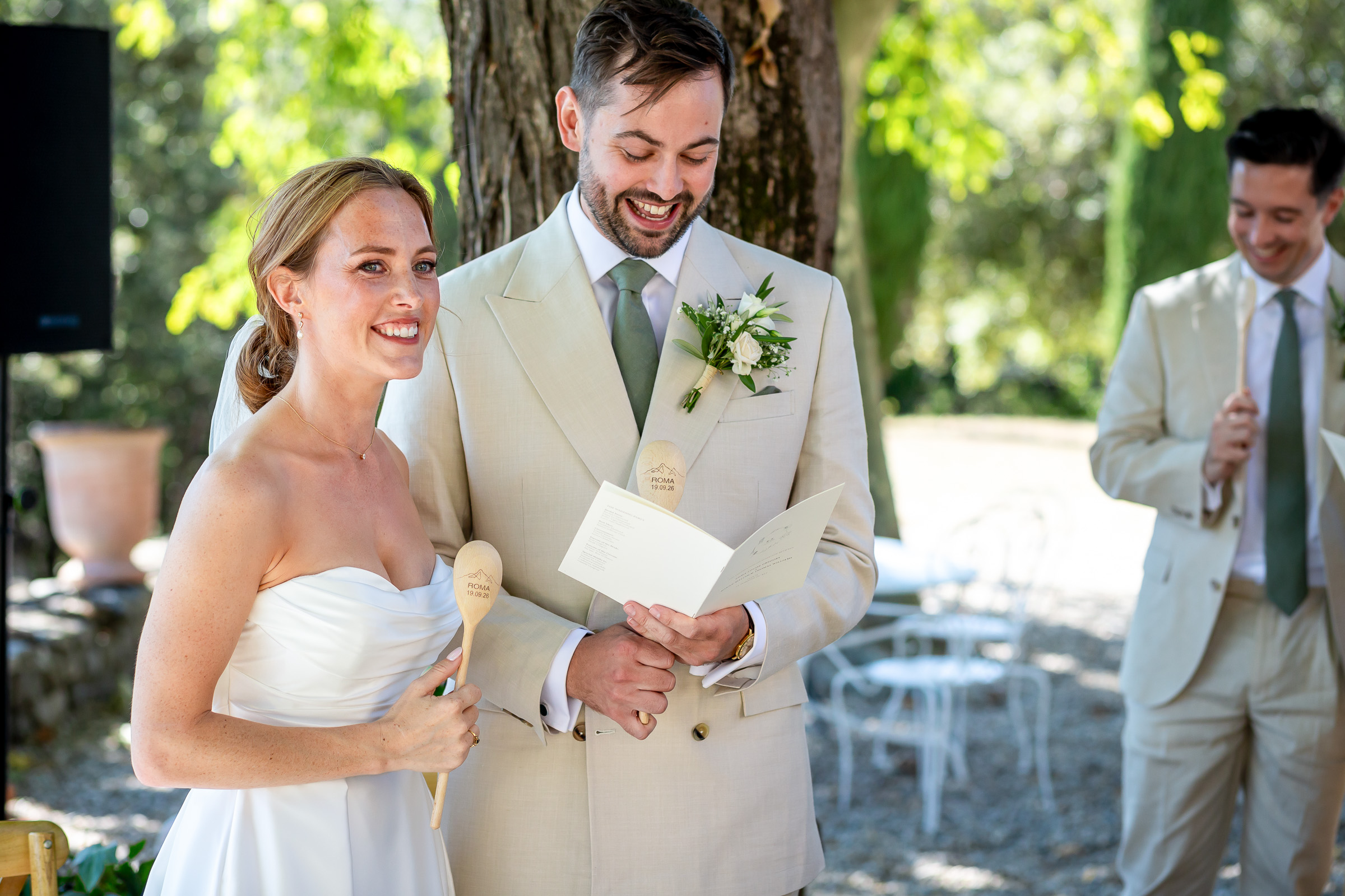 Emma and Rowan singing with wooden spoons during their ceremony