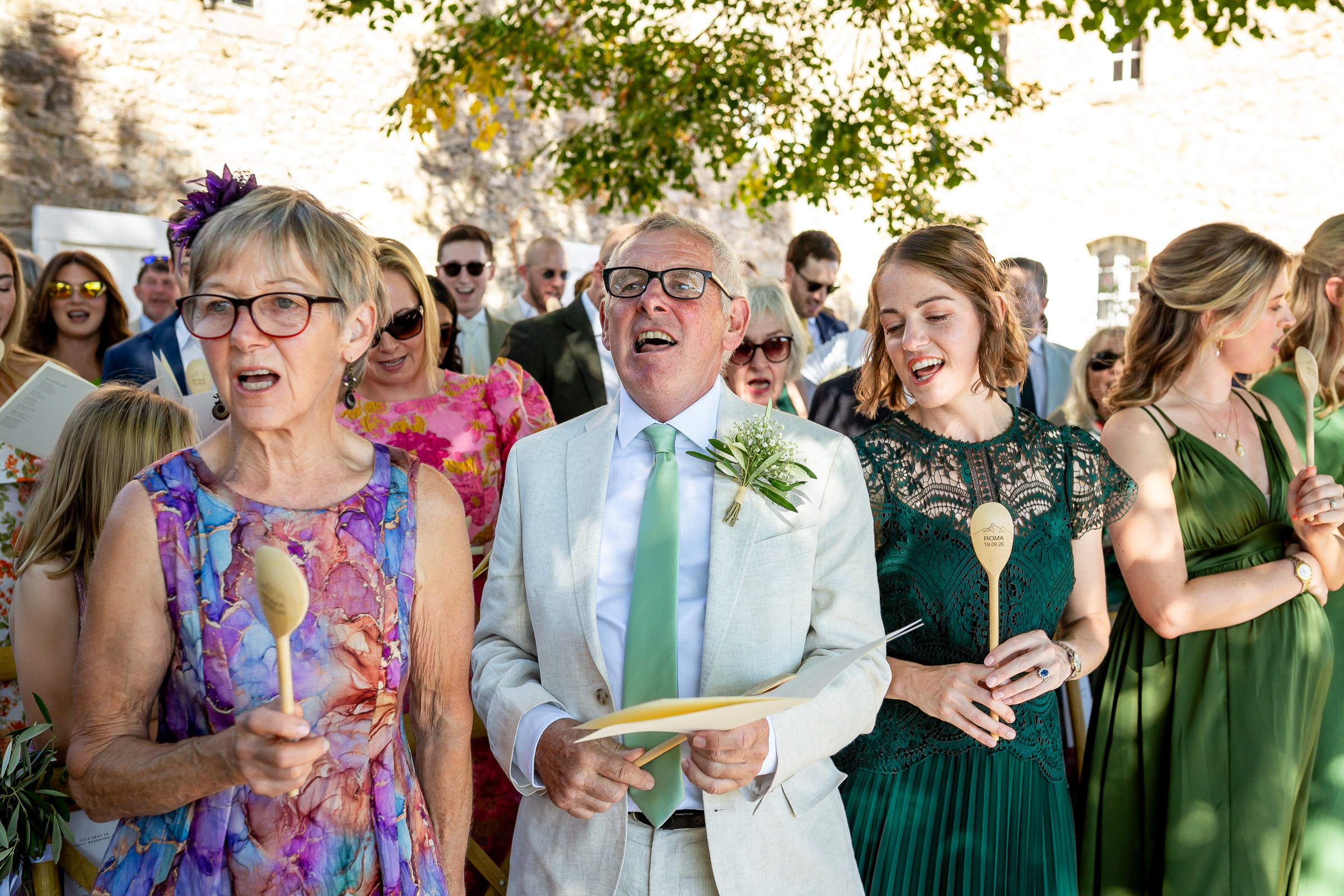 Wedding guests singing together during Emma and Rowan’s ceremony