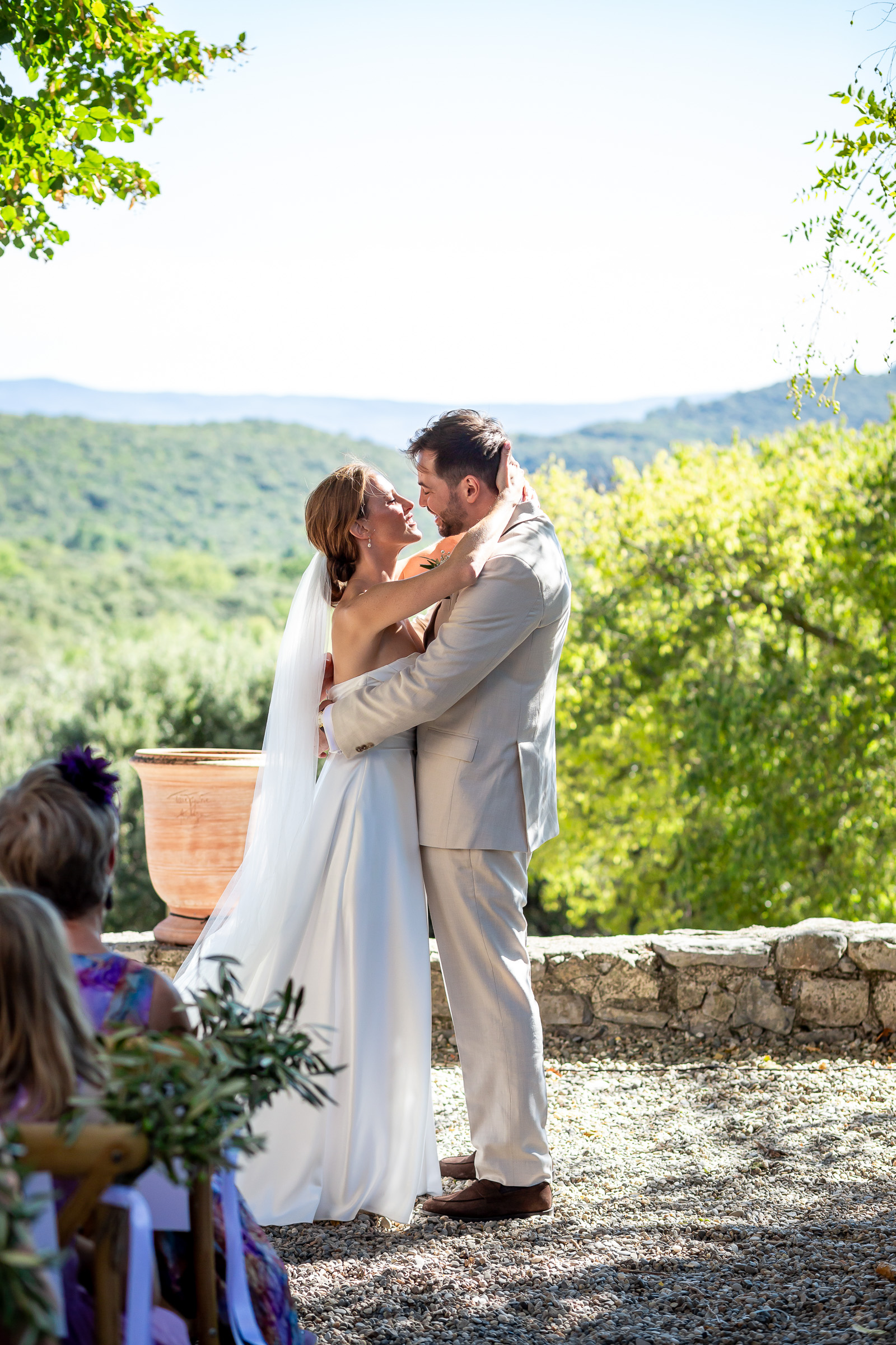 Emma and Rowan kissing during their outdoor ceremony