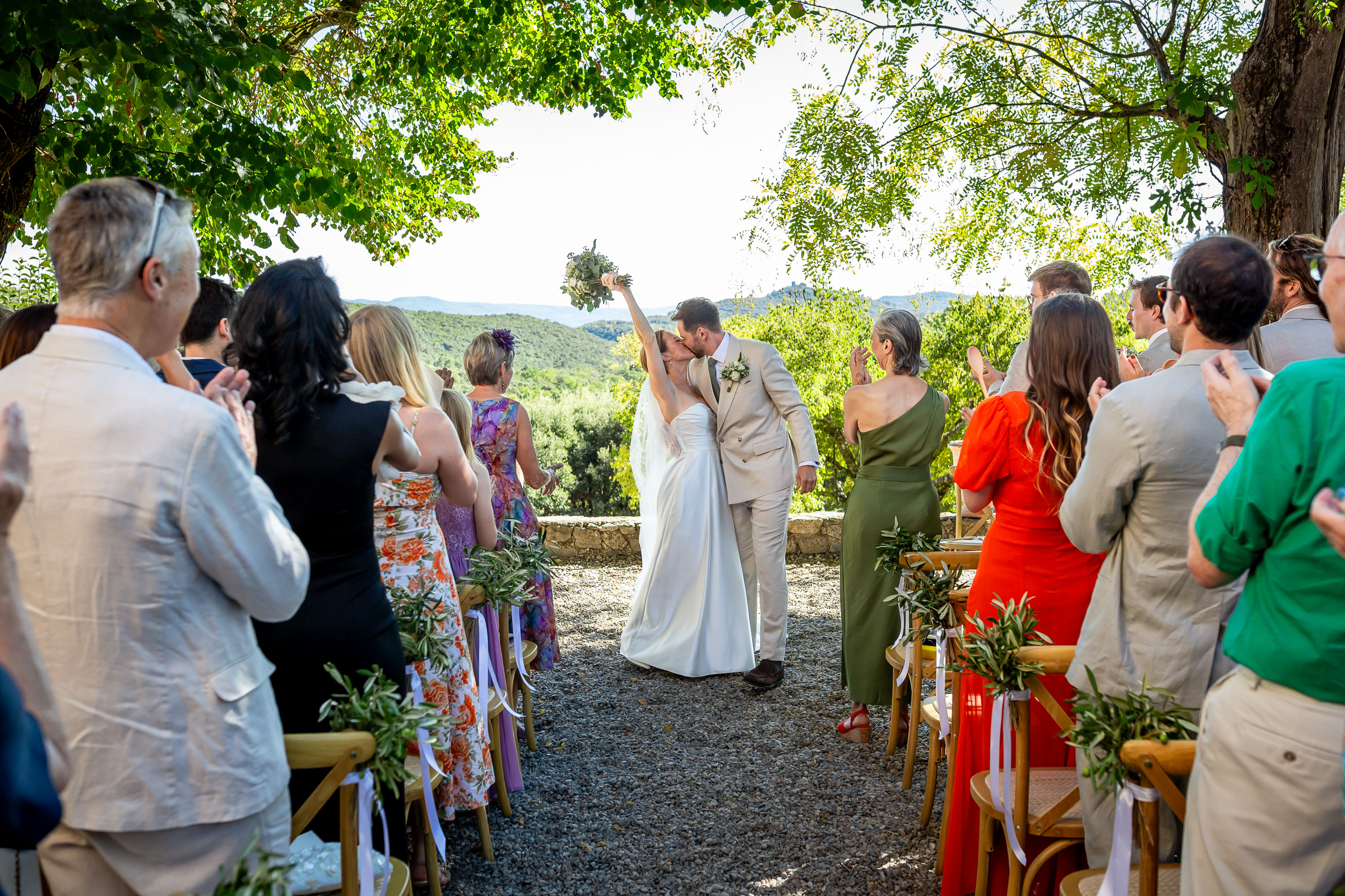 Emma and Rowan leaving the ceremony as guests applaud