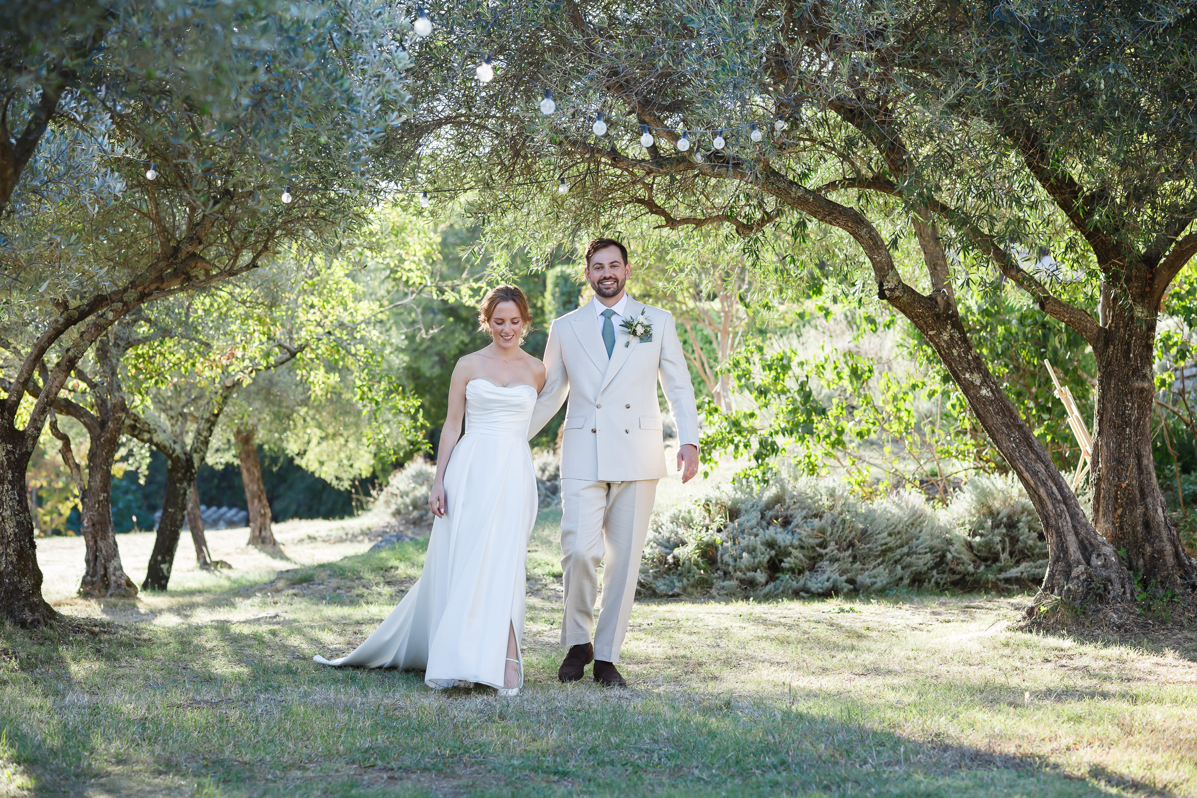 Relaxed landscape portrait of Emma and Rowan amongst the olive trees