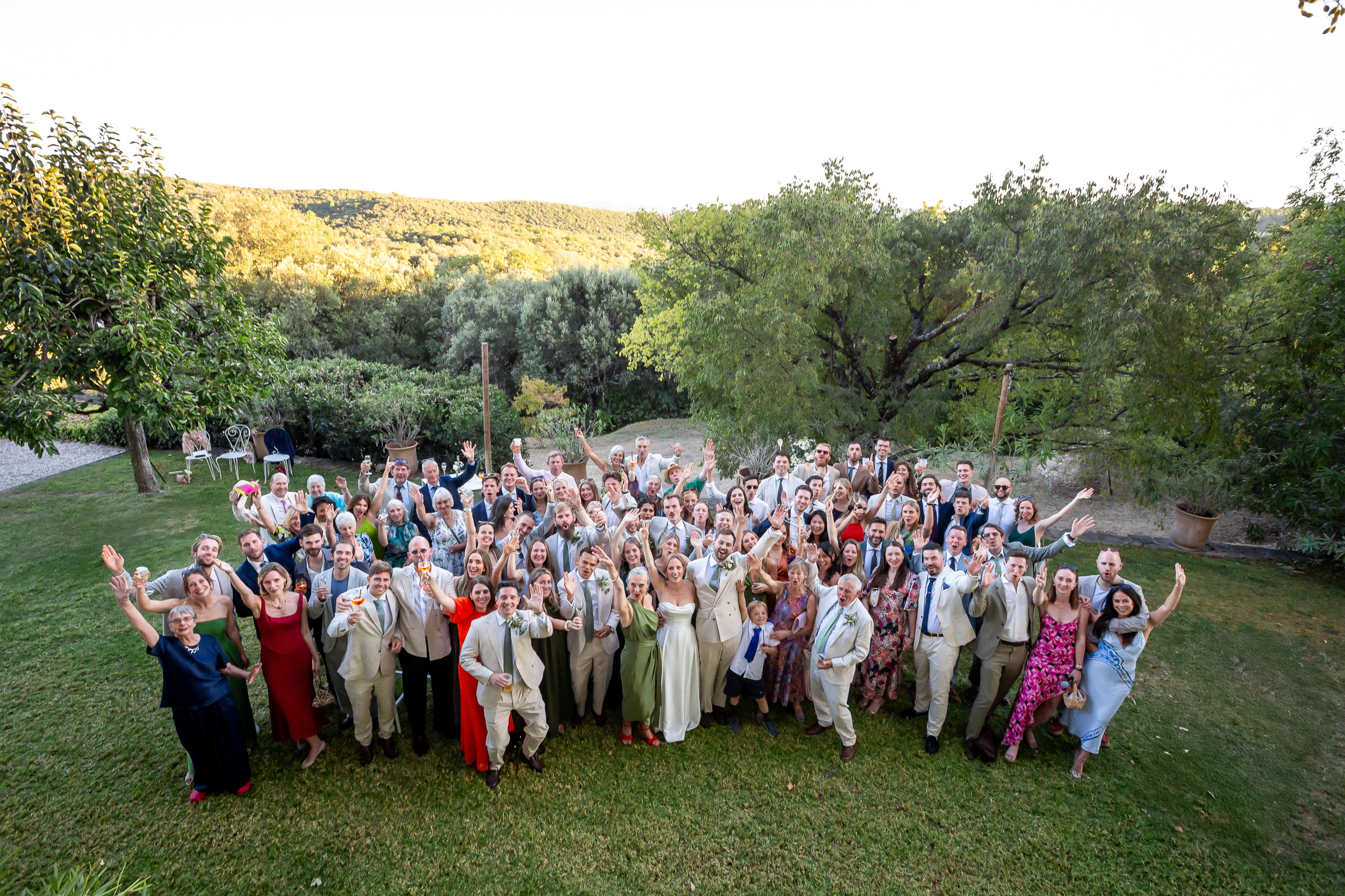 Large group photograph of the wedding guests at Le Domaine du Rey