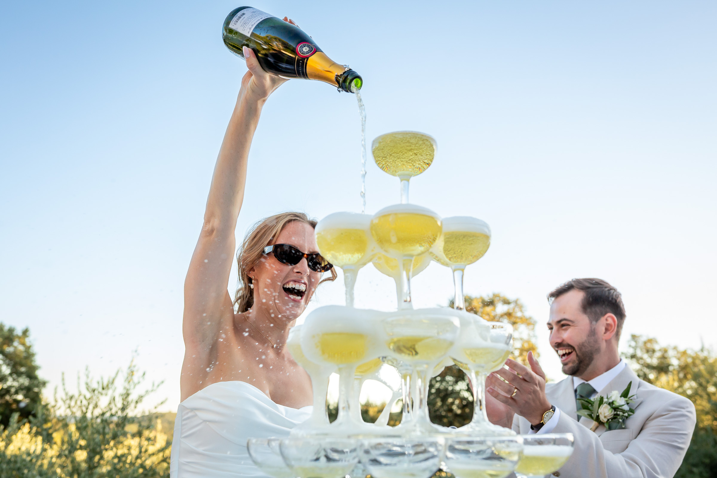 Emma pouring Champagne into the wedding Champagne tower