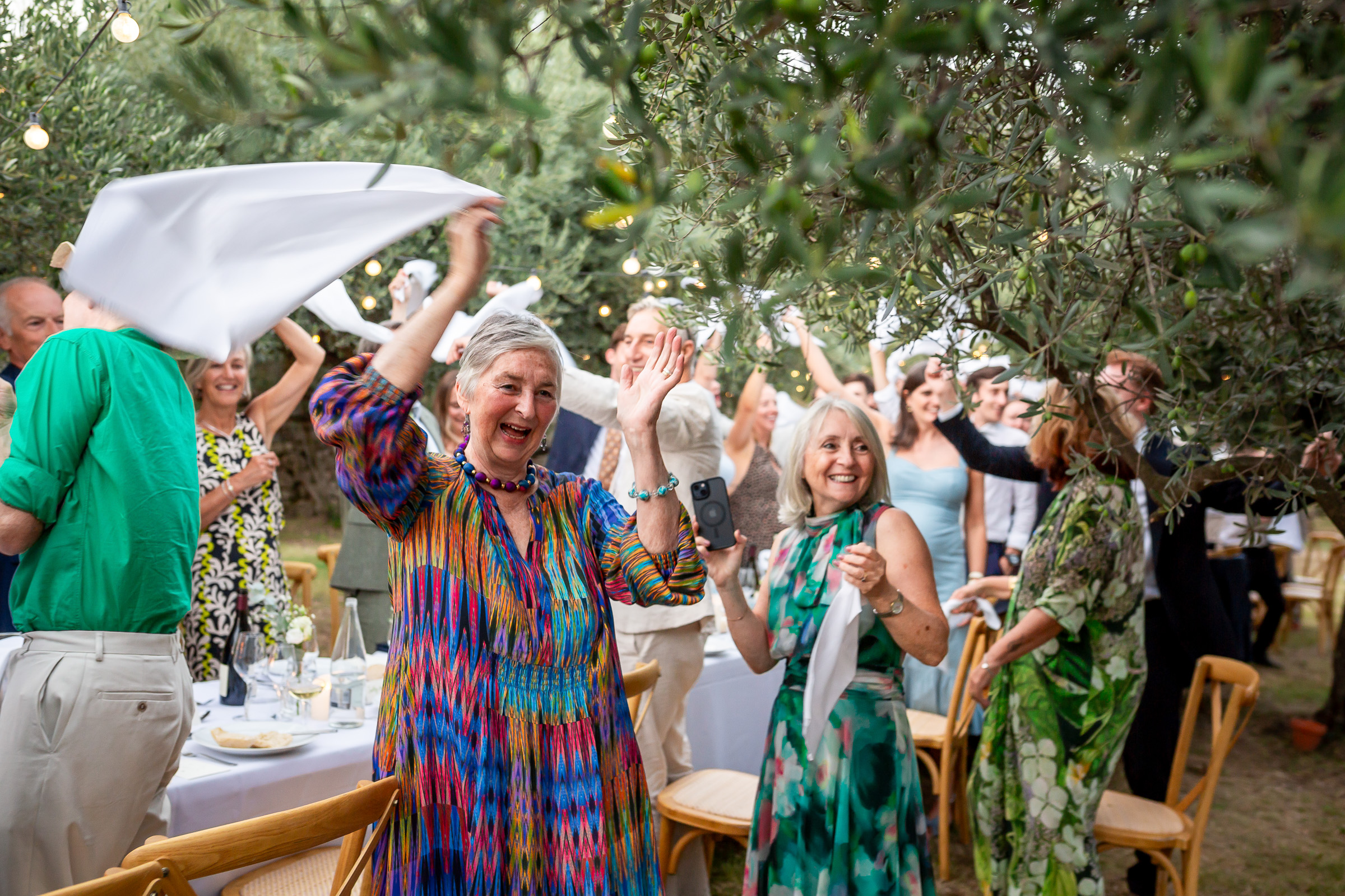 Guests cheering as Emma and Rowan enter their wedding breakfast