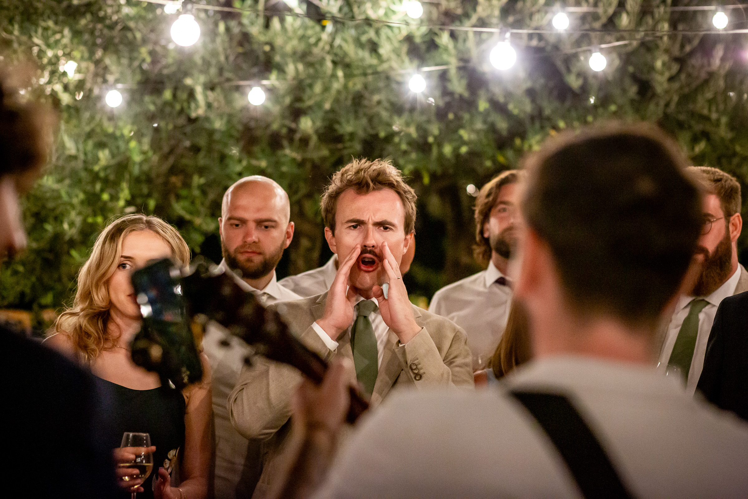 A singer performing close to the wedding tables