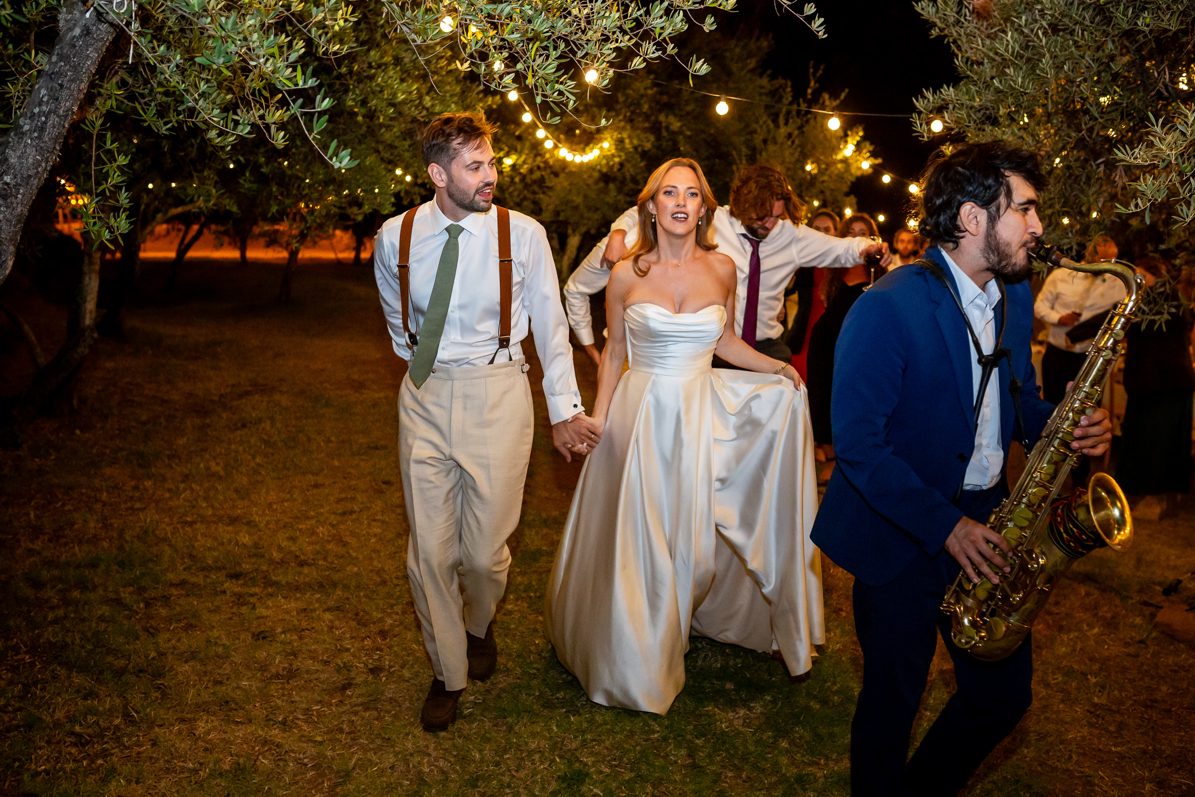 Emma and Rowan following the musicians towards the evening party